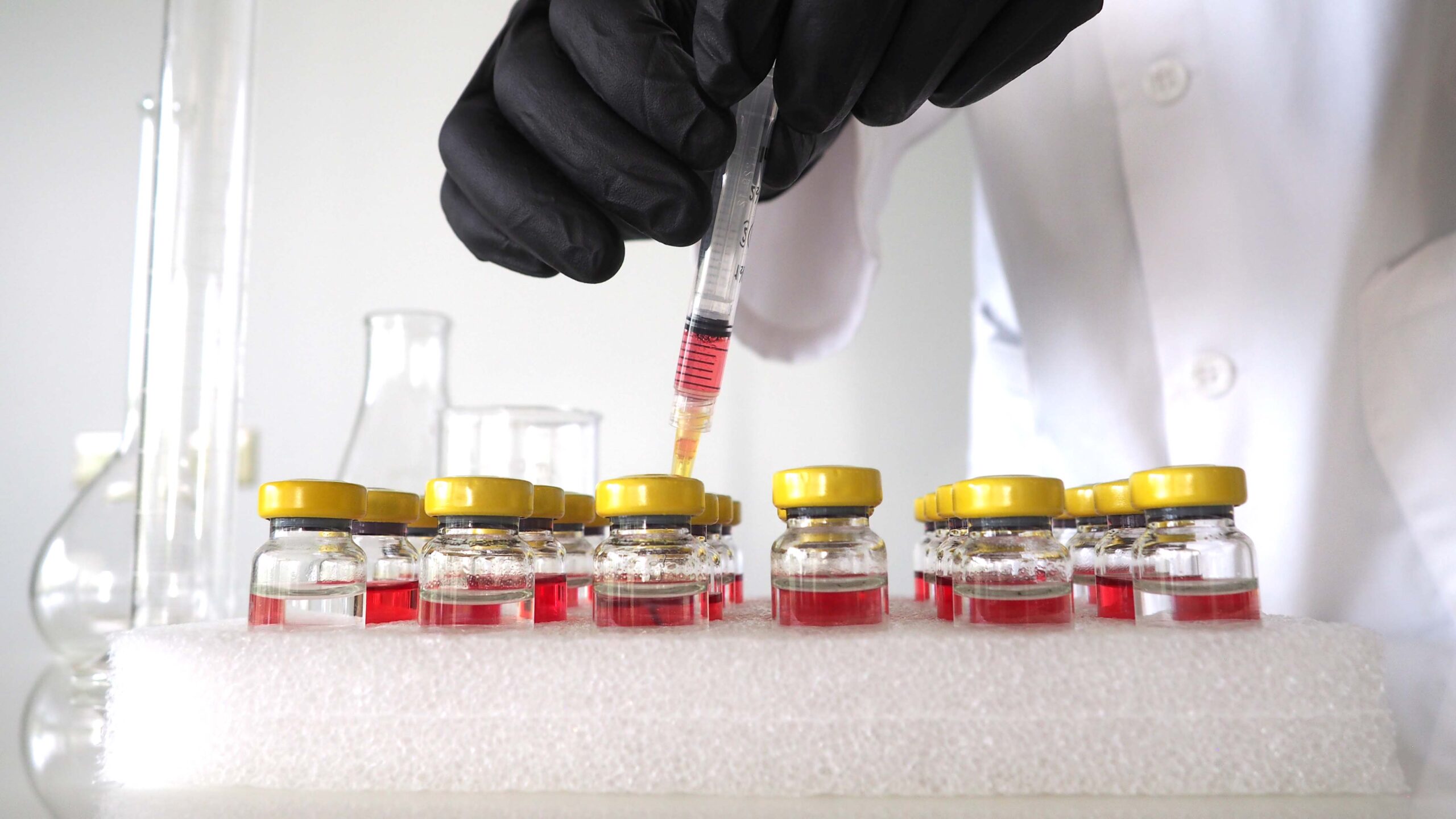 Post Frac Monitoring A scientist injects a culture bottle (bug bottle) with a treatment sample to test microbial control