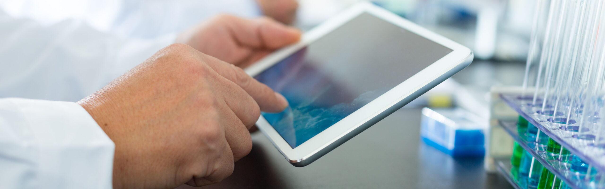 A chemist works on a tablet in the lab